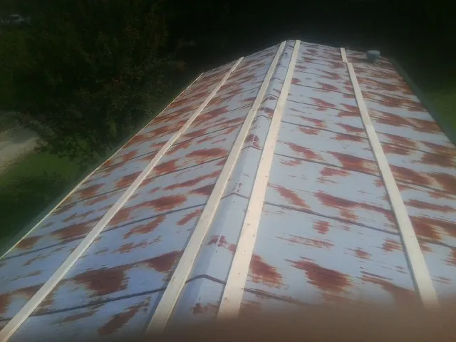 Rusted metal roof panels with new wood purlins before replacement — Storm Damage Roof Repair in Bel Air by Roofing Brothers