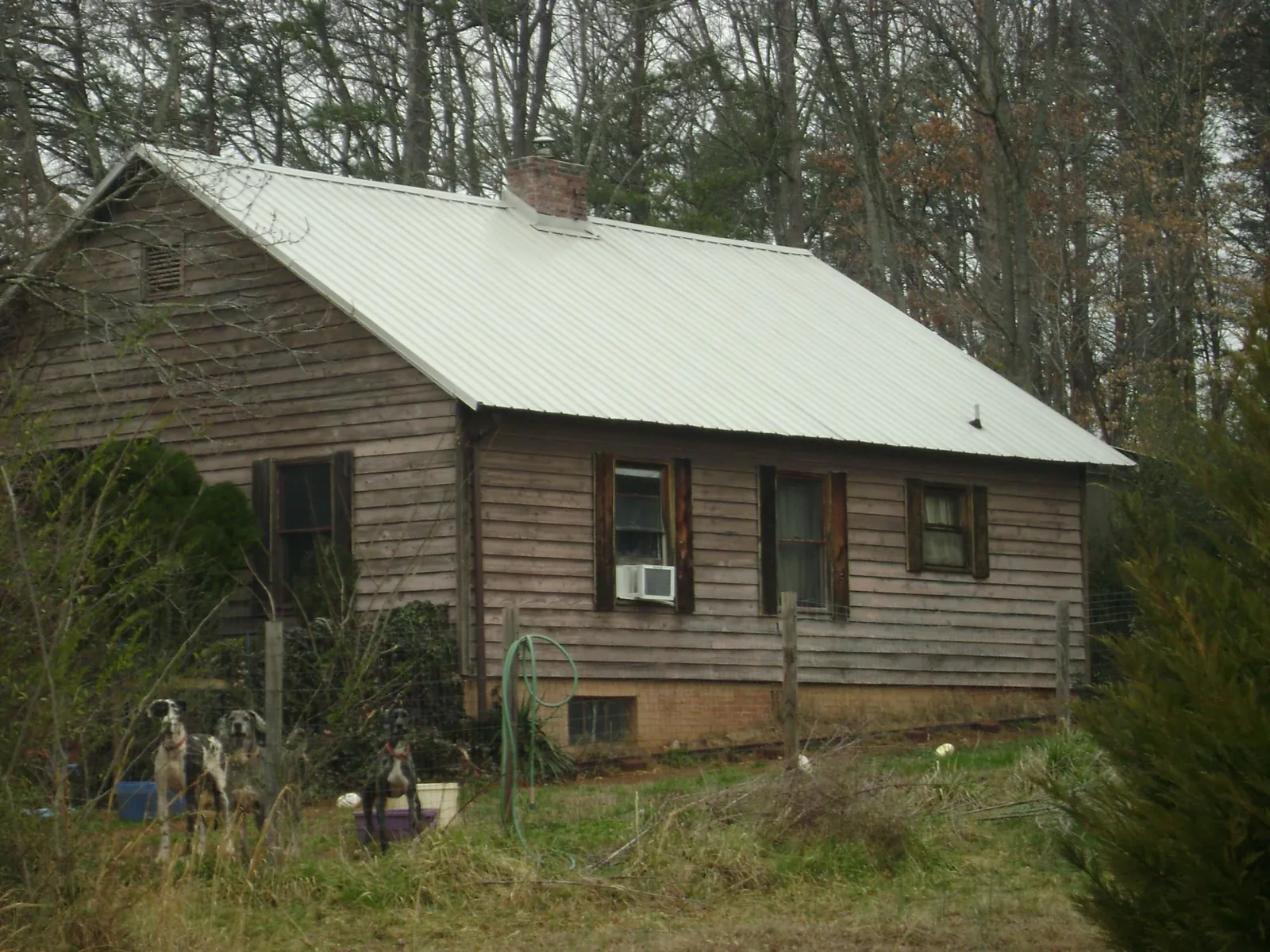 White metal roof on an old wood sided farmhouse, from a Metal Roof Installation job in Bel Air